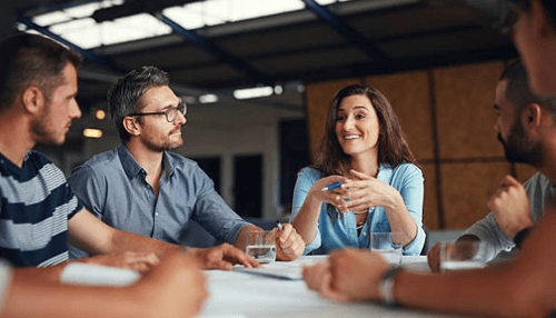 Budding entrepreneur Group discussion led by a budding entrepreneur, showcasing leadership, communication skills, collaboration, and innovative thinking in a business meeting.