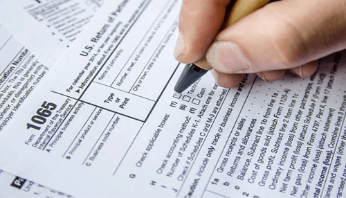 Business principal code on tax returns-tycoonstory | tycoonstory media Close-up of someone filling out tax forms, with a focus on the section for entering the principal business code