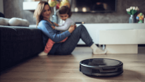 Robot mop Robot mop cleaning the living room floor while a mother and child relax on the sofa at home