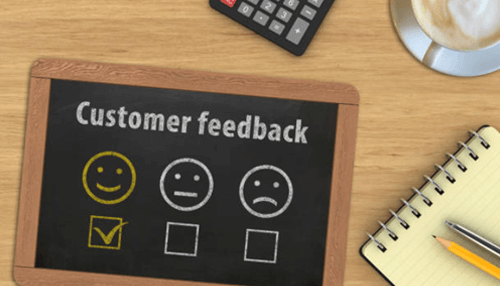 Customer feedback more effectively - tycoonstory | tycoonstory media A chalkboard with customer feedback options displayed as smiley, neutral, and sad faces, representing different levels of satisfaction in feedback collection.