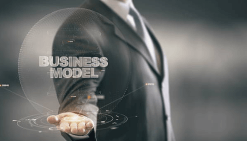 Establishing a strong business model-tycoonstory | tycoonstory media Businessman drawing stairs while another figure climbs, representing progress and achieving business milestones step by step.