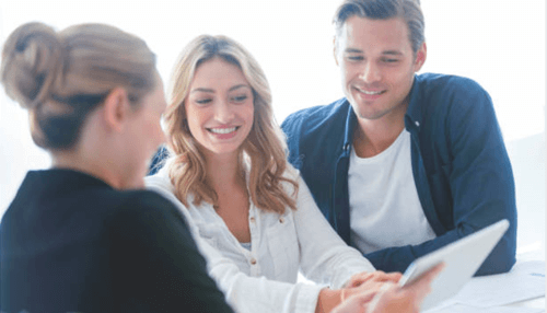 Females take up job roles for realestates -tycoonstory | tycoonstory media A couple meeting with a real estate agent while reviewing property details on a digital tablet.