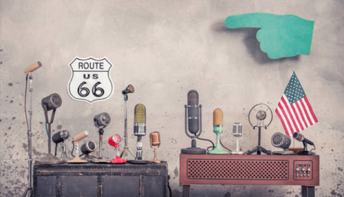 Top-tier translation agency An assortment of vintage microphones with a route 66 sign and an american flag, symbolizing a top-tier translation agency's wide-reaching network of independent linguists and global communication.