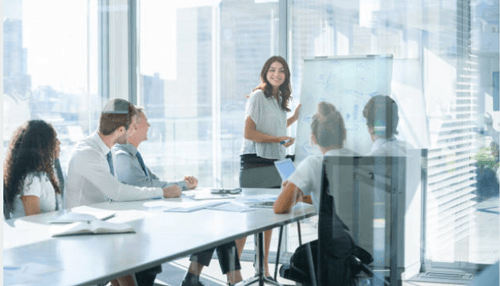 Ways to improve hr management in small companies-tycoonstory | tycoonstory media A woman leading a team meeting in a modern office, showcasing collaboration, training, and effective hr management practices.