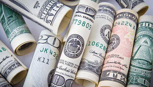 Price matters Rolled-up dollar bills representing financial resources for app building and startup investments