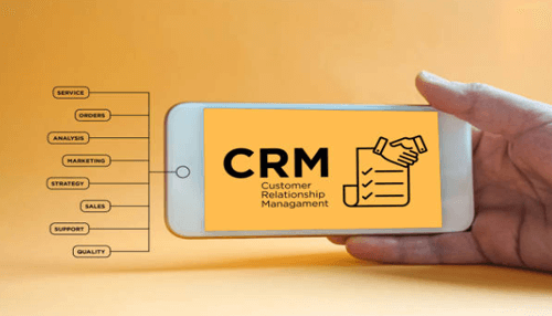 Customer relationship management-tycoonstory | tycoonstory media Hand holding a smartphone displaying a crm dashboard with labels for service, marketing, sales, and support, illustrating customer relationship management.