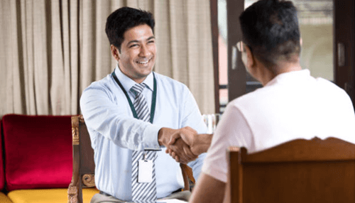 Open a hotel Business professional shaking hands with a client during a meeting, symbolizing partnership and planning to open a hotel.