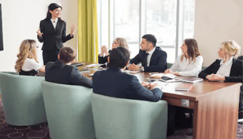 Good mentee Professional woman leading a meeting, displaying strong communication skills, a key trait of a good mentee in fostering collaborative learning.