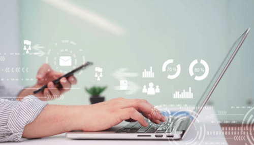 Running a business Businessperson using smartphone and laptop - managing business challenges with digital tools.