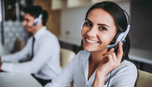 Use csr staff to increase sales Customer support executive smiling while wearing a headset, showcasing effective communication in business management.