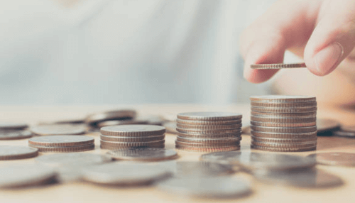 How to invest in direct mutual funds A person stacking coins, symbolizing saving and investing, potentially in mutual funds for building wealth.