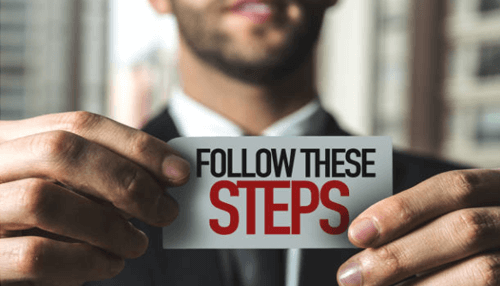 Important steps to follow-tycoonstory | tycoonstory media Businessman holding a card that reads'Follow These Steps,' guiding the process of a personal injury claim.