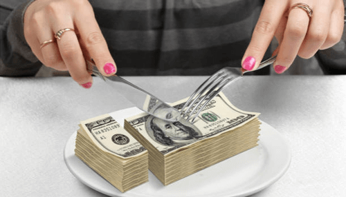 Tips to keep your budget Person slicing stacks of money on a plate with a fork and knife, symbolizing financial management or budgeting.