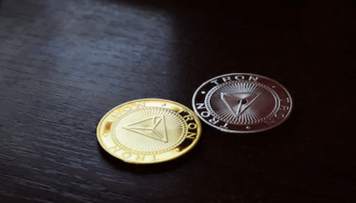 What is tron Gold and silver tron coins placed on a dark surface, representing cryptocurrency trading concepts such as btc to trx conversions.