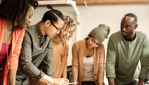 Mba A diverse group of young professionals working together on a project, showcasing teamwork and collaboration in an mba program.