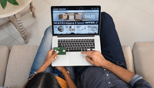 Buying process difficulty Couple shopping online during the buying process, browsing sales and offers on a laptop with a credit card.