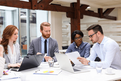 B2b business ideas Diverse corporate team discussing documents and strategies during a meeting, highlighting collaboration and innovative b2b business ideas in a modern office.