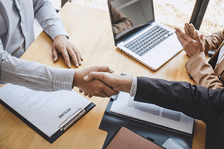 Create an impressive resume-tycoonstory | tycoonstory media Successful handshake during a job interview, candidate chosen for the job