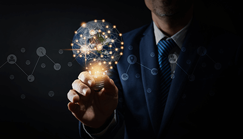 Great leader Businessman holding a glowing lightbulb with a digital globe and network connections, symbolizing innovation, ideas, and the power of technology.