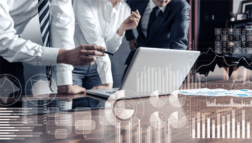 It consultancy and support Business professionals collaborating around a laptop with data charts and analytics overlays, illustrating how companies outsource for business success