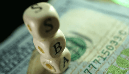Resources for aspiring entrepreneurs Stacked dice spelling sba on top of money, representing small business financing options.