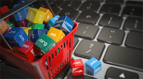 Domain name for online business-tycoonstory | tycoonstory media Colorful domain name blocks in a shopping basket on a keyboard, symbolizing the shift from offline business to online digital presence.