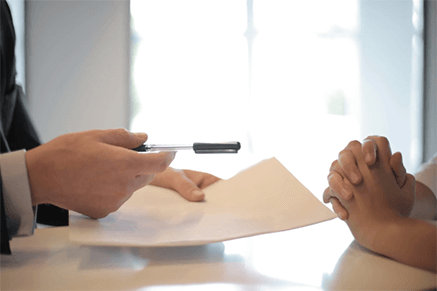 Kyc documents for personal loan-tycoonstory | tycoonstory media Bank representative offering documents and a pen to a customer, symbolizing the approval process for personal loans in delhi.
