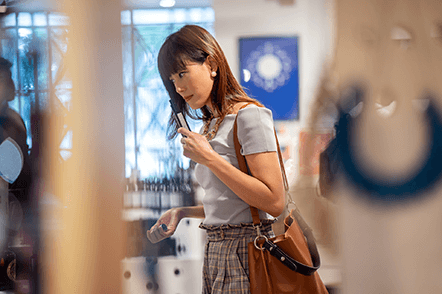 Scent marketing-tycoonstory | tycoonstory media Business owners can enhance customer experiences by incorporating scent marketing into their stores, as shown by a shopper interacting with the retail environment.