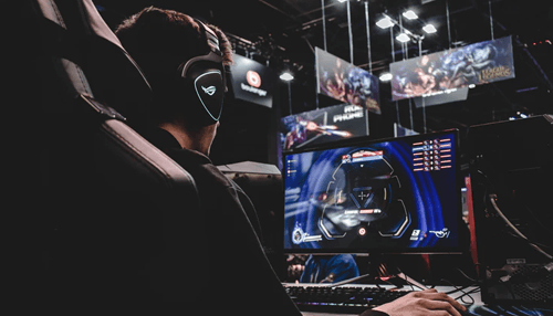Game development Professional esports player using a high-performance gaming pc and headset, representing competitive gaming and modern game development environments.