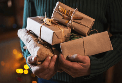 E-commerce business Person holding eco-friendly wrapped parcels, representing sustainable packaging trends in the e-commerce business during the holiday shopping season.