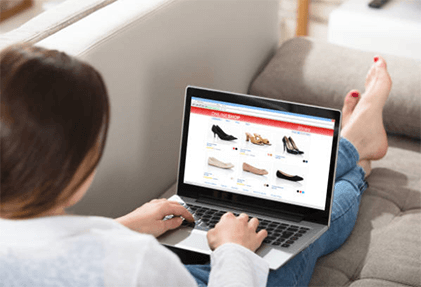 Make online shopping more easy-tycoonstory | tycoonstory media A woman shopping for shoes on an ecommerce website from her laptop, highlighting the convenience and accessibility of online shopping.