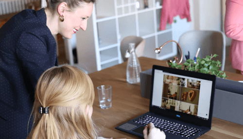 Leadership skills Collaborative team working at a shared workspace with laptops and planners, highlighting teamwork and leadership skills in a productive office setting.