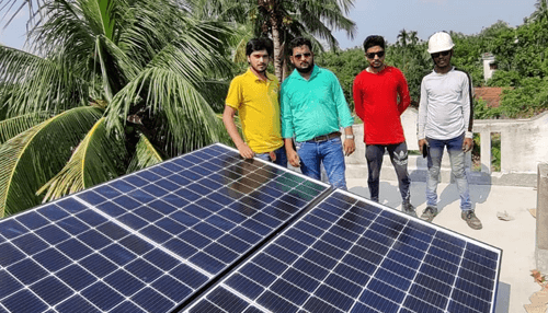 Solar energy Team of technicians standing beside rooftop solar panels for a solar energy installation.