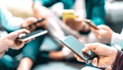 1xbet mobile review - tycoonstory | tycoonstory media Group of people using smartphones, representing users browsing the 1xbet online betting site on their mobile devices.