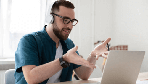 Advantages of online work experience - tycoonstory | tycoonstory media A person engaged in a virtual work experience meeting, participating in a video call while working from home with headphones and a laptop