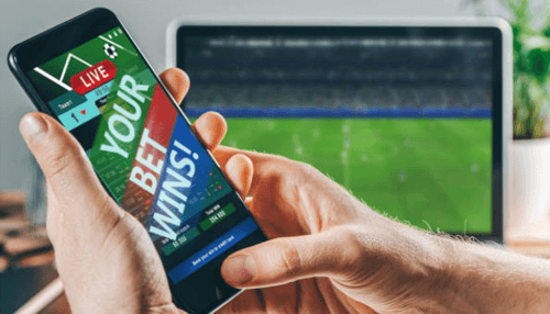 Bookmakers charge freebet - tycoonstory | tycoonstory media Smartphone displaying live betting results with a message'Your bet wins', showcasing free bets in sports betting.