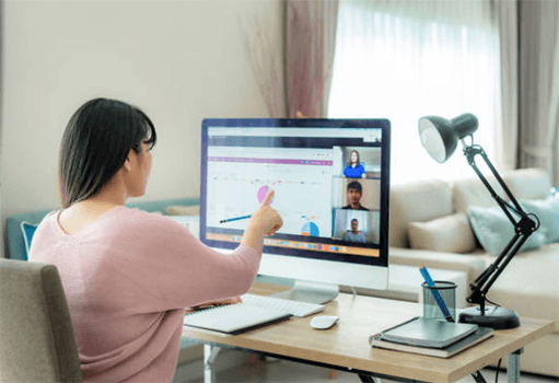 Applications to run your business A person participating in a remote meeting using gotomeeting on a desktop, showcasing the ease of running your business remotely with videoconferencing apps.