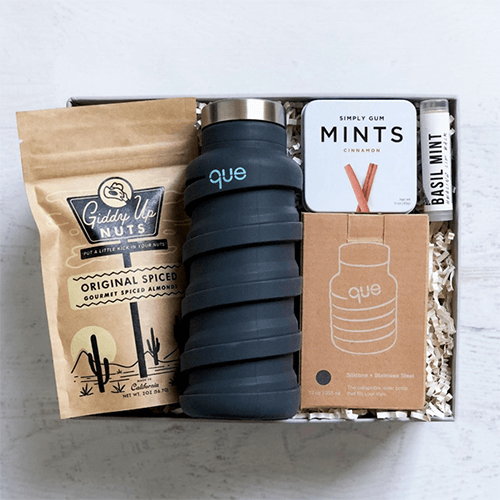 Corporate gift basket-swag box-tycoonstory | tycoonstory media Gift box with a collapsible que bottle, simply gum mints, giddy up nuts, basil mint lip balm, and eco-friendly items.