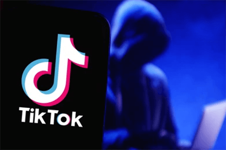 Tiktok Tiktok logo displayed on a smartphone screen with a shadowed figure symbolizing online security and privacy concerns on tiktok.