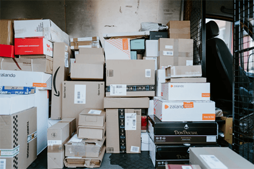 How to expand ecommerce business internationally-tycoonstory | tycoonstory media A van filled with stacks of packages, reflecting the logistics and distribution processes essential for an efficient ecommerce business.