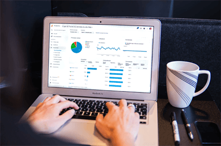 How to expand online business internationally-tycoonstory | tycoonstory media A person analyzing business analytics on a laptop screen, highlighting key metrics and insights crucial for running a successful ecommerce business.