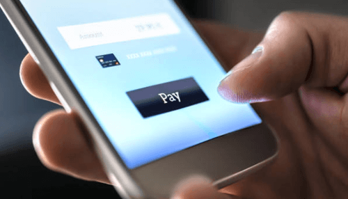 Casino online payment - tycoonstory | tycoonstory media A close-up shot of a person making a payment using a smartphone for an online casino transaction.