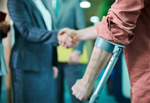 Tips in getting a personal injury lawyer-tycoonstory | tycoonstory media A personal injury lawyer shaking hands with a client using crutches, symbolizing the legal support and assistance provided in personal injury claims.