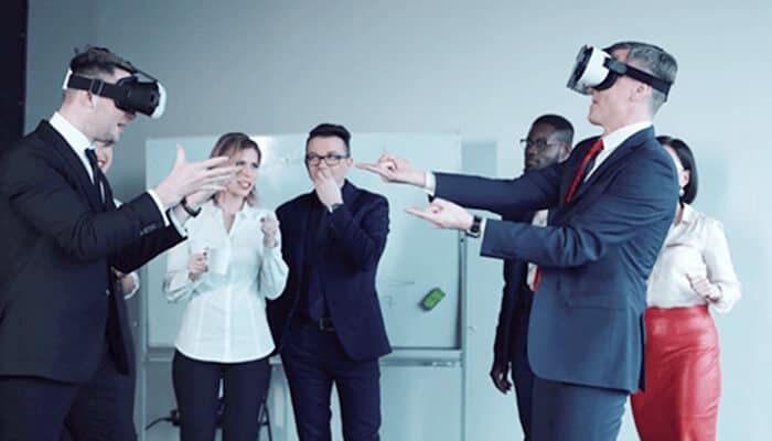 Training scenarios | tycoonstory media Corporate team experiencing virtual reality technology during a collaborative meeting and interactive training session.