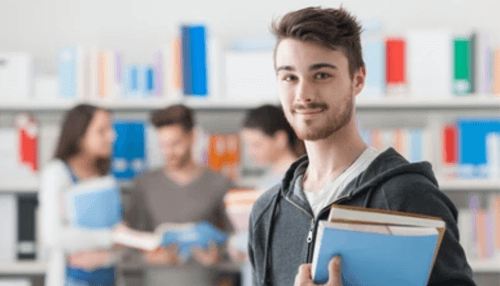 What are the most crucial tips to be taken into consideration at the time of choosing the uk education consultants in delhi city-tycoonstory | tycoonstory media Young student holding books in a library, symbolizing education and planning for long-term financial goals.