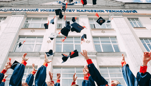Masters degree Graduates tossing caps in the air to celebrate completing a masters degree, symbolizing academic success and higher education achievement.