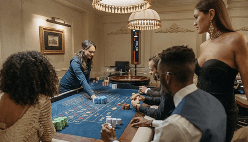 Legalized sports betting industry creates new job opportunities - tycoonstory | tycoonstory media Players gathered around a casino roulette table, highlighting the excitement and atmosphere of sports betting and gambling entertainment.
