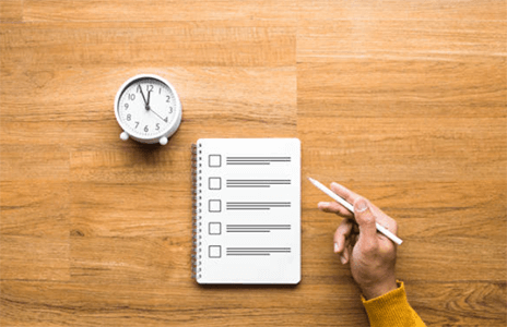 Stress management tips for online students-tycoonstory | tycoonstory media Online learner reviewing a checklist with a clock in the background, indicating time management for tasks.