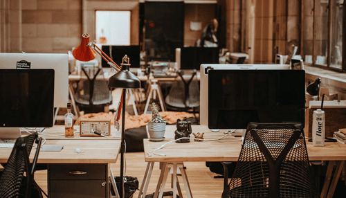 Build a custom application - tycoonstory | tycoonstory media Modern office space of a software development company with workstations, computers, and a collaborative environment for tech professionals