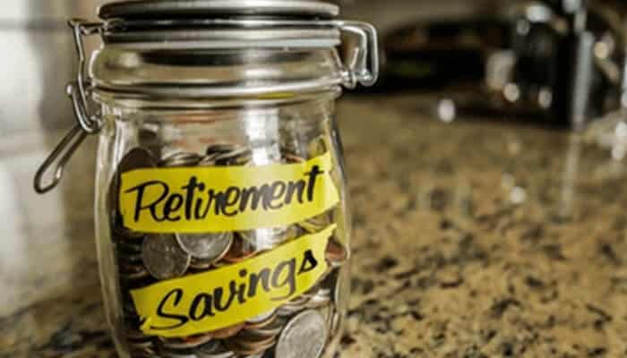 Fjjkkkk | tycoonstory media Retirement investment savings jar filled with coins, representing long-term financial security and retirement planning goals